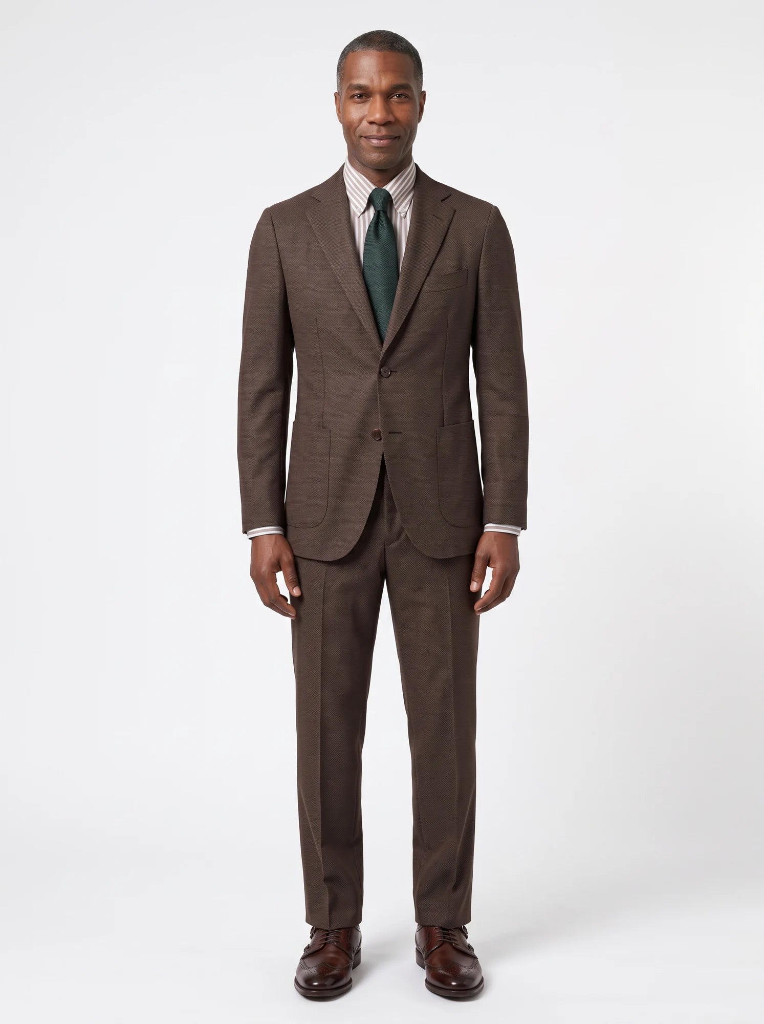 A full-length brown suit showing shoulder balance, sleeve length and trouser drape