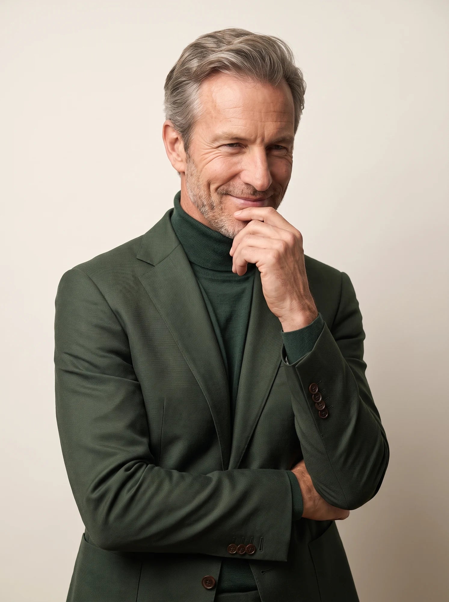 A relaxed portrait in a forest-green suit and tonal knit
